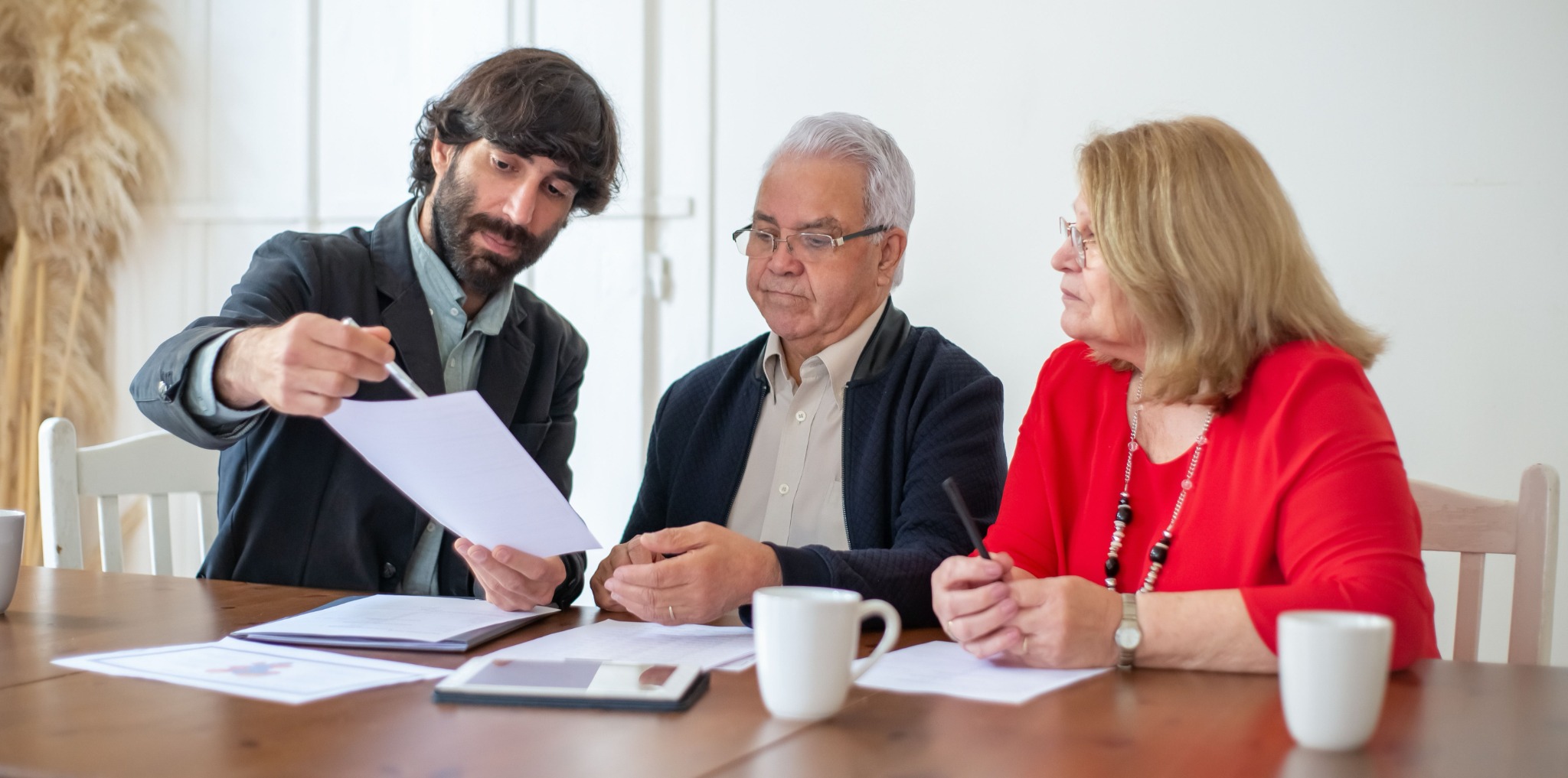 An advisor reviewing documents with two older adults at a table