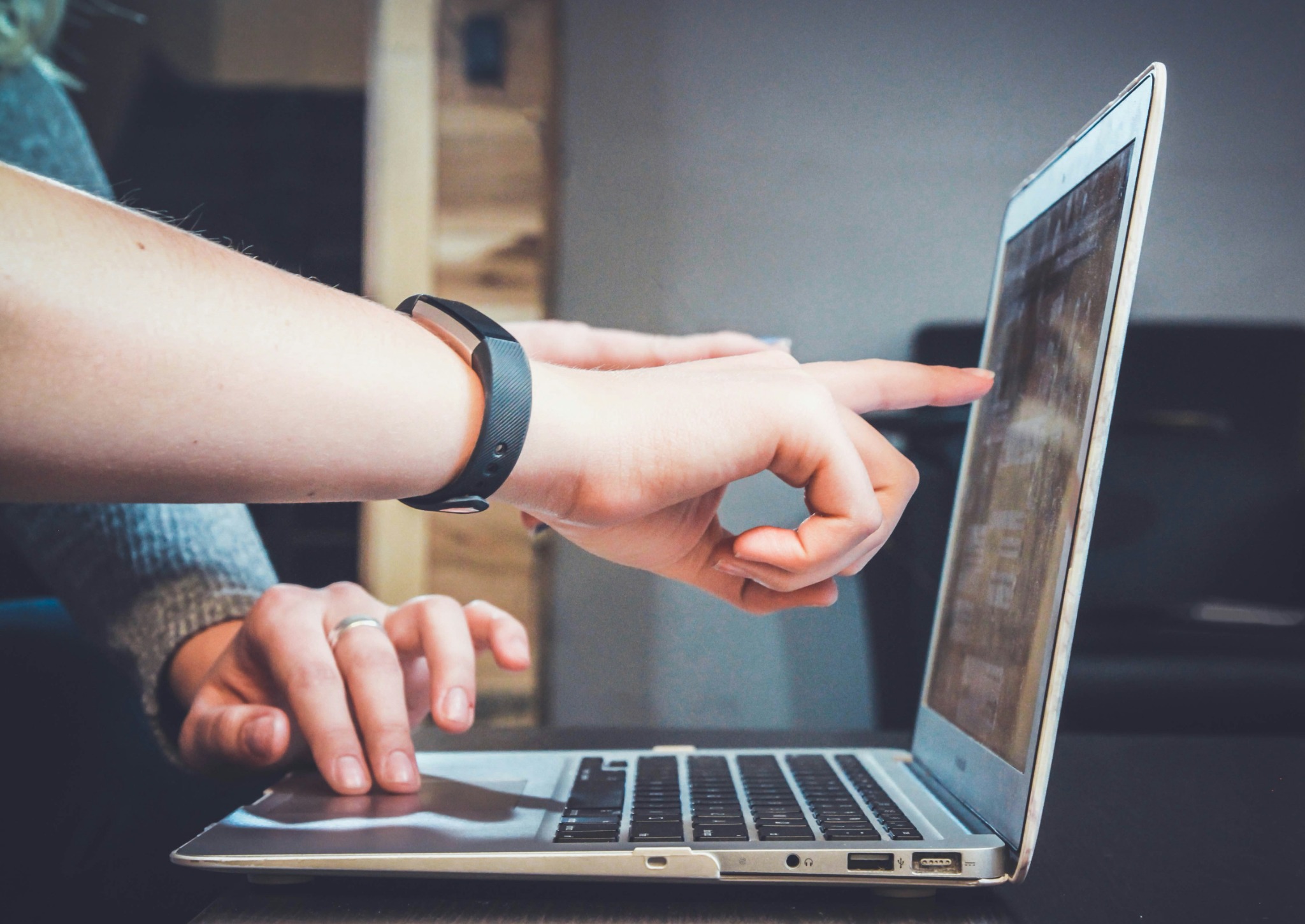 People reviewing information on a laptop